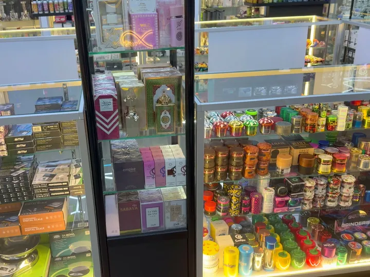 Glass cases with digital scales on the left, boxed perfumes in the centre and colourful grinders on the right
